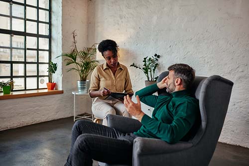 Client in a therapy session with a mental health professional at North Star Treatment, receiving personalized care in a calming, supportive environment.